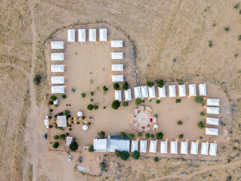 Aerial shot of a tented desert camp in Jaisalmer, India. Ideal for travel and adventure imagery.